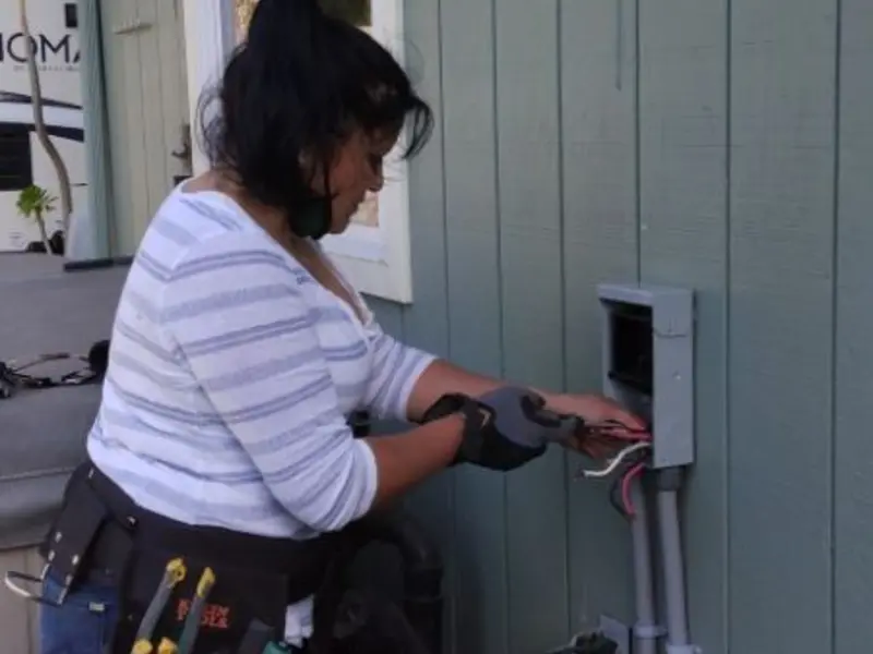 Licensed electrician wiring an exterior subpanel in Waunakee